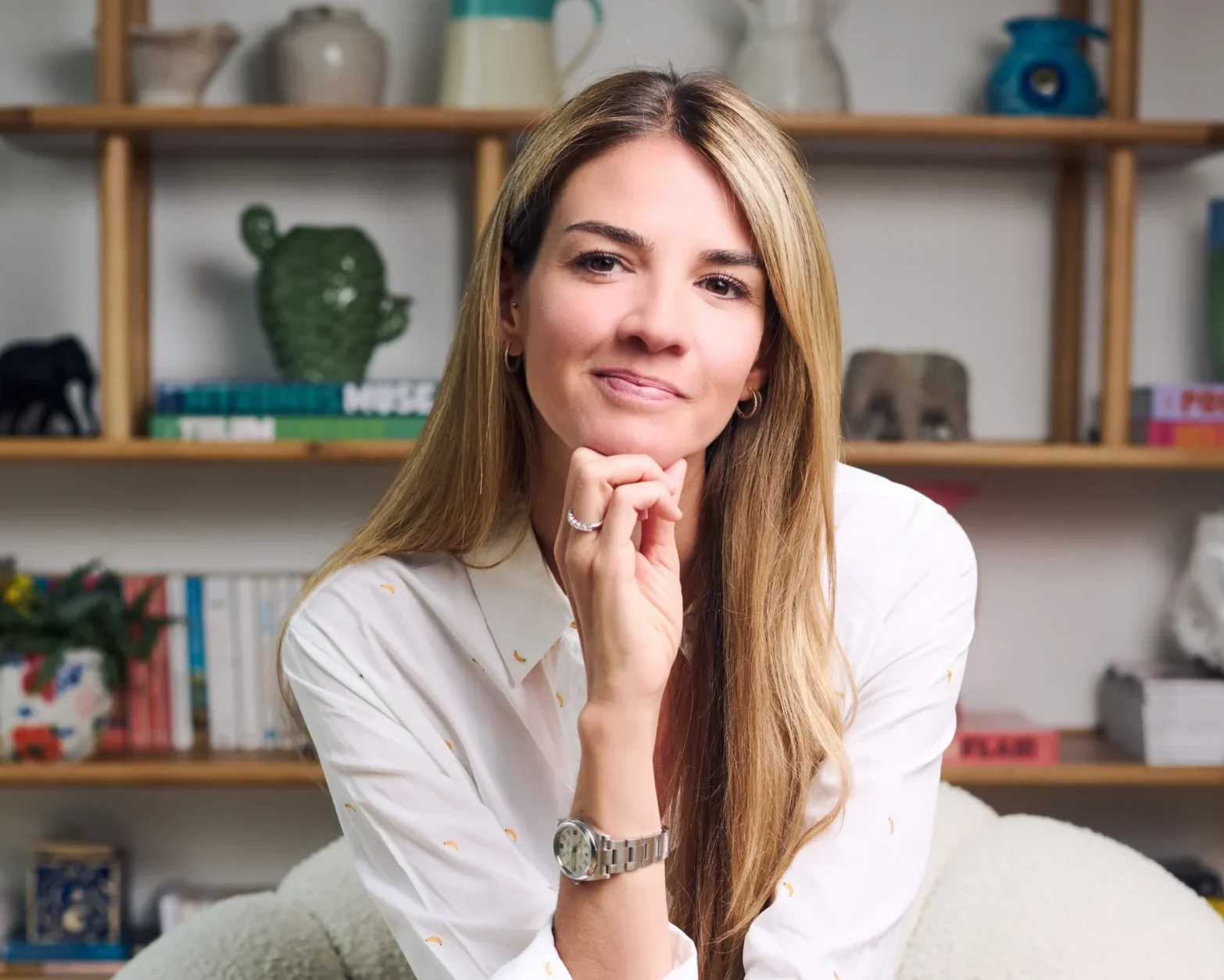 Holistic life coach in London, Olivia Vaughan, relaxing on a chair.